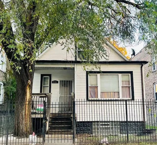 bungalow featuring a gate, a porch, and a fenced front yard