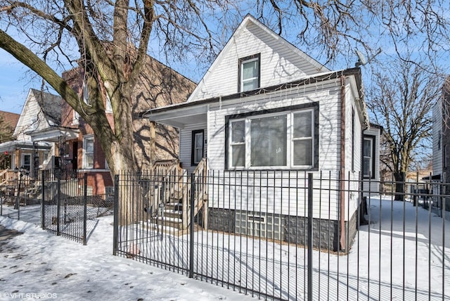 view of front of house with a fenced front yard and a gate
