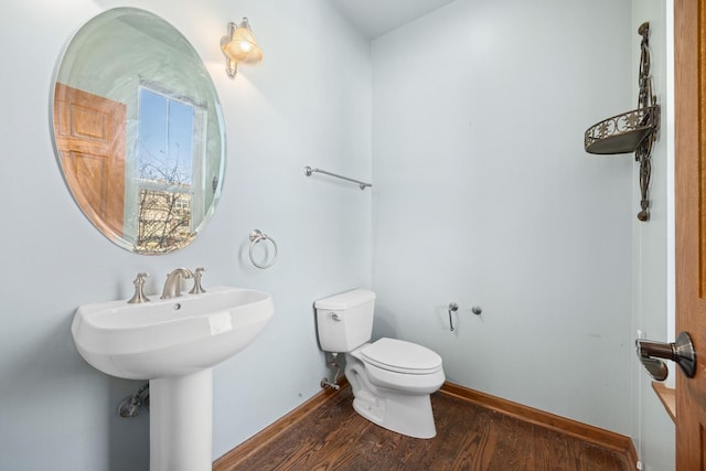 11253 Victoria Ln, Huntley, IL 60142 - half bath with baseboards, wood finished floors, toilet, and a sink