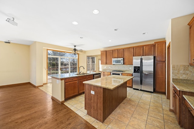 11253 Victoria Ln, Huntley, IL 60142 - kitchen featuring decorative backsplash, appliances with stainless steel finishes, a kitchen island, and a sink