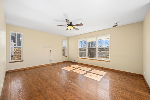 11253 Victoria Ln, Huntley, IL 60142 - spare room featuring baseboards, wood finished floors, and a ceiling fan