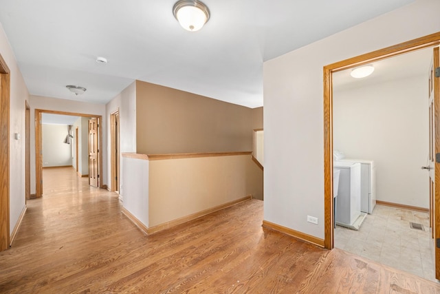 11253 Victoria Ln, Huntley, IL 60142 - hall with light wood-type flooring, baseboards, and washing machine and dryer