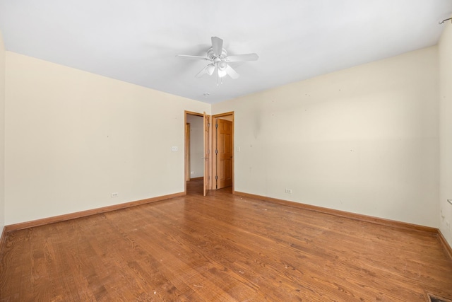 11253 Victoria Ln, Huntley, IL 60142 - spare room featuring baseboards, wood finished floors, and ceiling fan