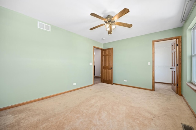 11253 Victoria Ln, Huntley, IL 60142 - unfurnished bedroom featuring a walk in closet, visible vents, light colored carpet, and baseboards