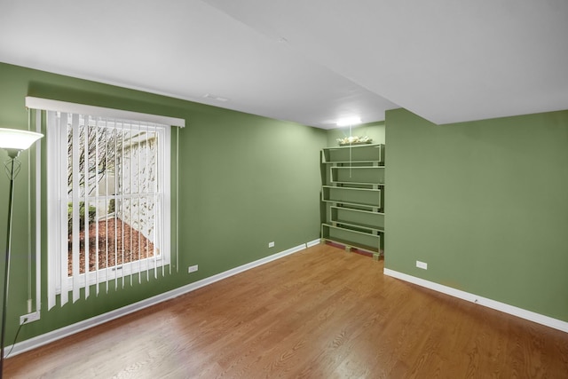 interior space featuring baseboards and wood finished floors