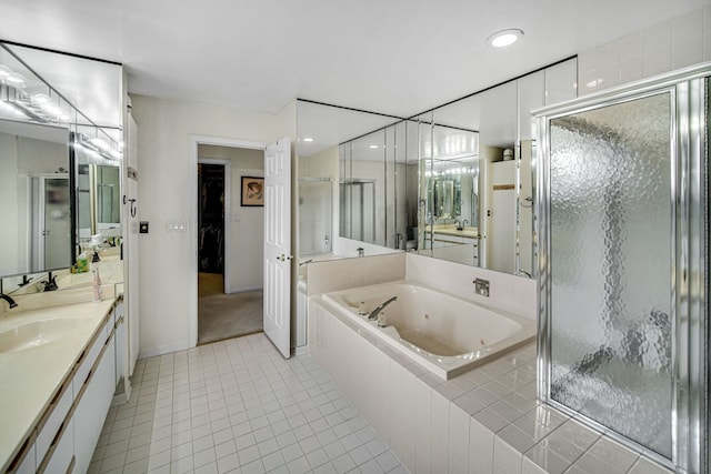full bathroom with vanity, a jetted tub, a stall shower, baseboards, and tile patterned flooring