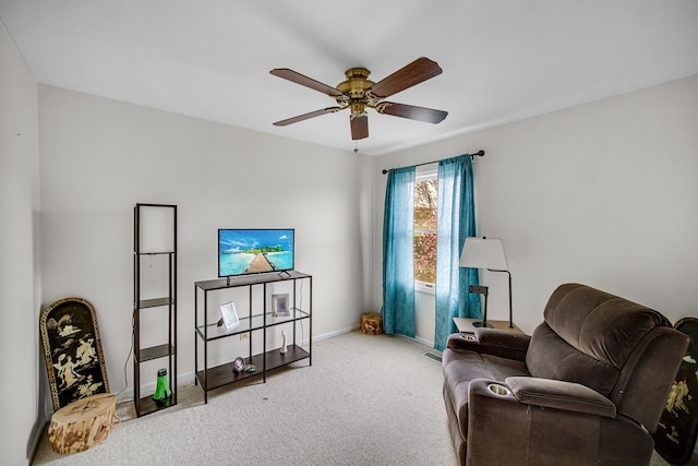 living area featuring a ceiling fan, carpet flooring, and baseboards