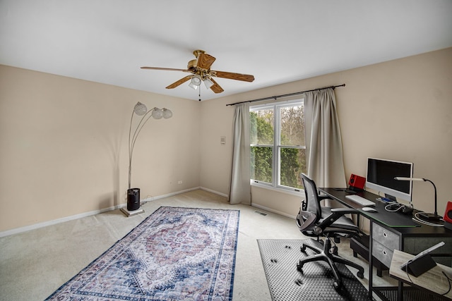 carpeted office with visible vents, ceiling fan, and baseboards