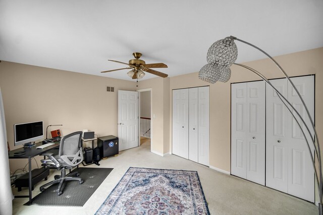 office space featuring ceiling fan, baseboards, visible vents, and carpet floors