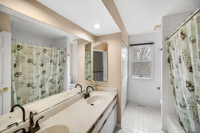 full bathroom with visible vents, toilet, tile patterned flooring, and a sink