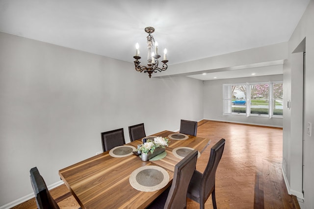 dining room with recessed lighting, an inviting chandelier, wood finished floors, and baseboards
