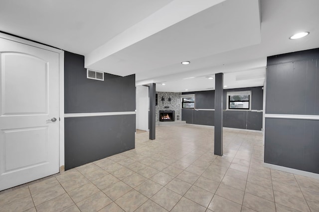 interior space featuring light tile patterned floors, recessed lighting, visible vents, and a fireplace
