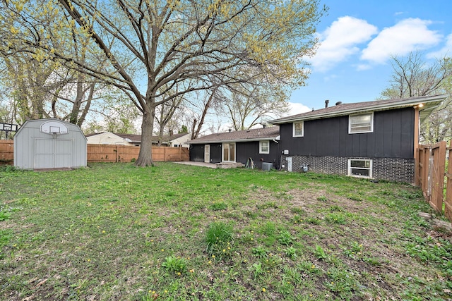 view of yard with an outbuilding, a shed, a sunroom, and a fenced backyard