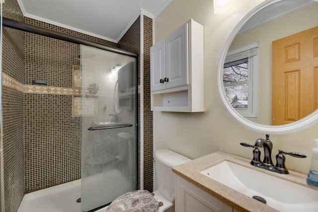 full bath featuring a shower stall, toilet, crown molding, and vanity