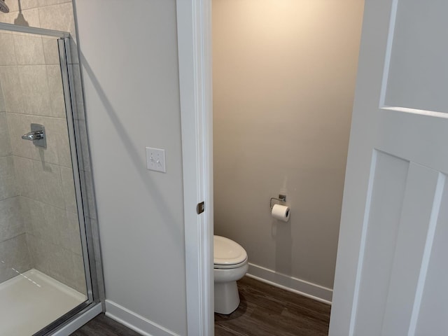 1840 Tall Oaks Dr, Antioch, IL 60002 - bathroom featuring a stall shower, toilet, baseboards, and wood finished floors