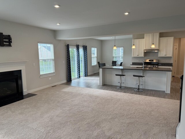 1840 Tall Oaks Dr, Antioch, IL 60002 - kitchen with dark countertops, open floor plan, baseboards, range, and recessed lighting
