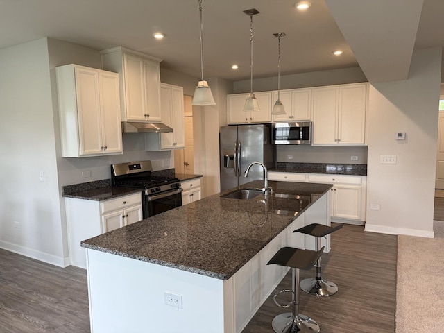 1840 Tall Oaks Dr, Antioch, IL 60002 - kitchen with appliances with stainless steel finishes, a sink, under cabinet range hood, baseboards, and dark wood-style flooring
