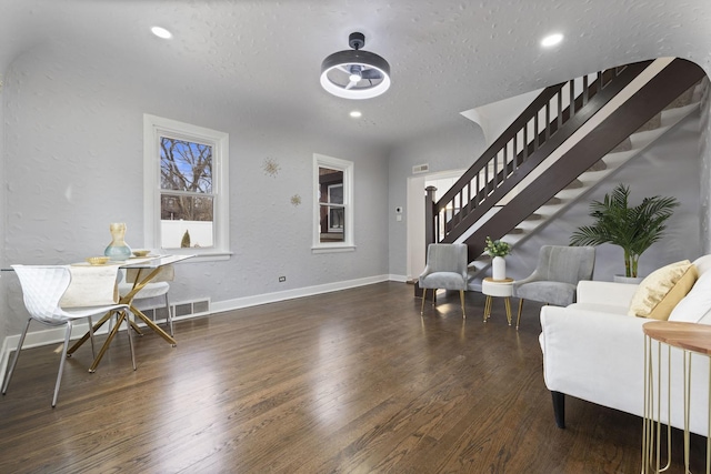 foyer featuring stairway, wood finished floors, baseboards, a textured ceiling, and recessed lighting