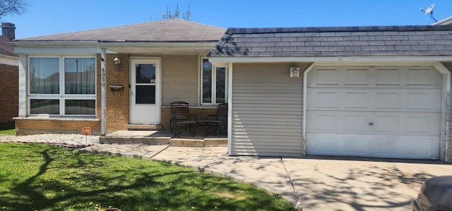 view of front of property with roof with shingles, an attached garage, driveway, and mansard roof