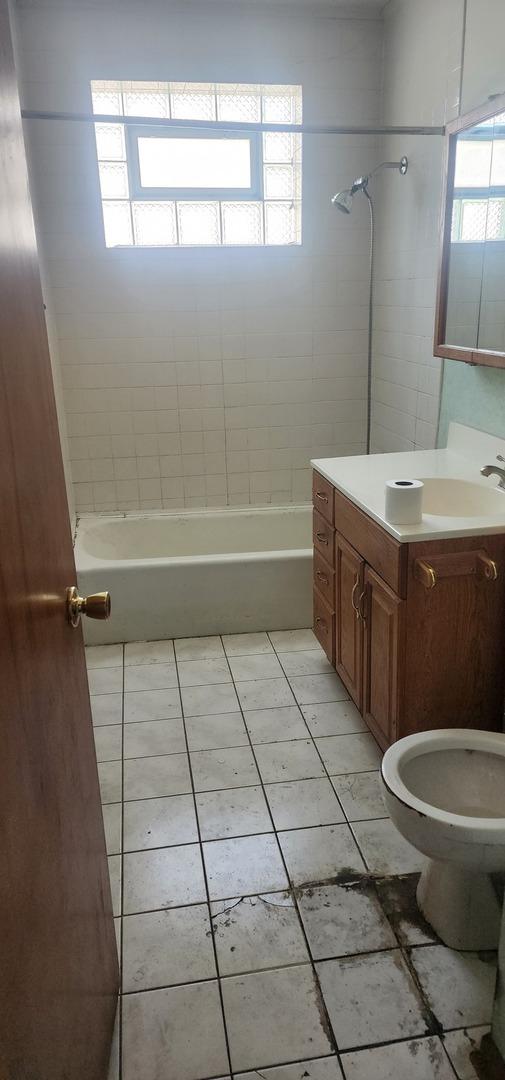 full bath with vanity, tile patterned flooring, and shower / tub combination
