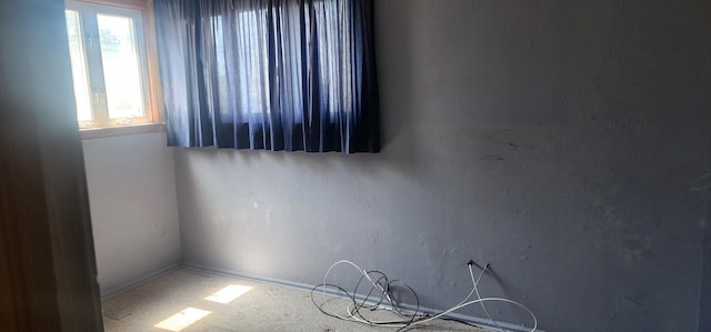 spare room with carpet flooring and baseboards