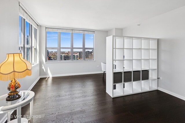 unfurnished bedroom featuring wood finished floors and baseboards