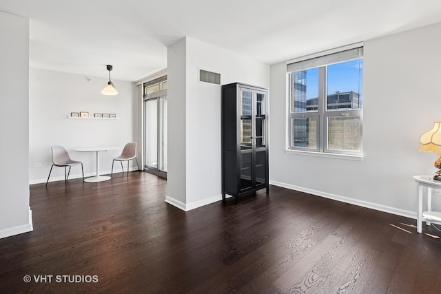 living area with wood finished floors and baseboards