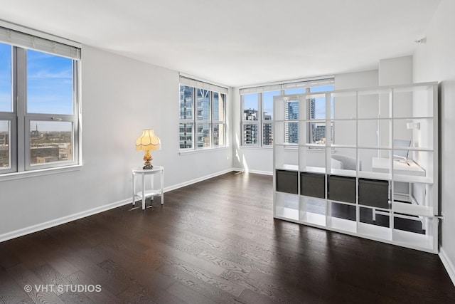 empty room with wood finished floors and baseboards