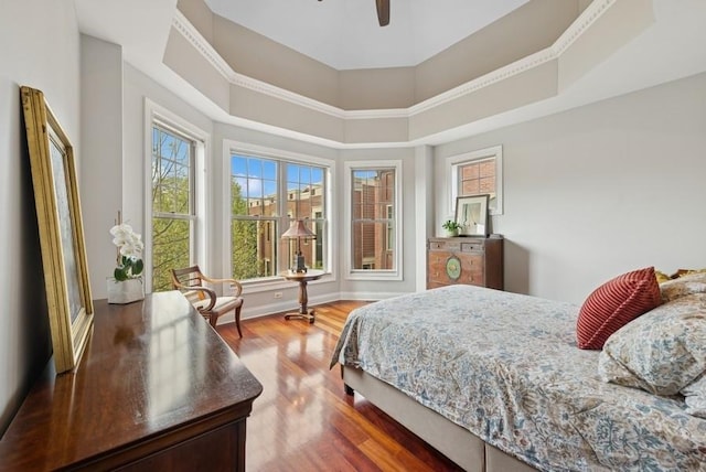 bedroom featuring baseboards, a ceiling fan, and wood finished floors