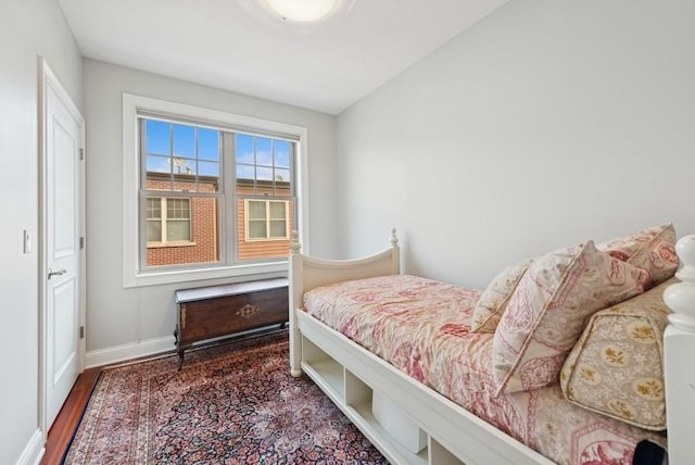 bedroom featuring baseboards and wood finished floors