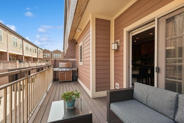 balcony with an outdoor living space, a residential view, and a grill