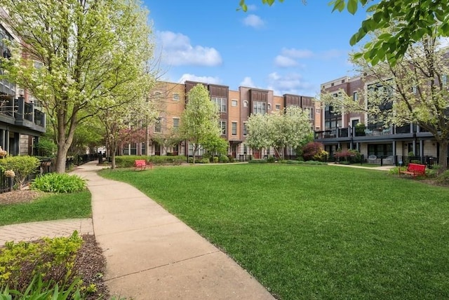 view of property's community with a lawn
