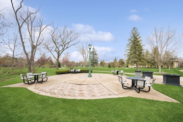 view of property's community with a patio area and a yard