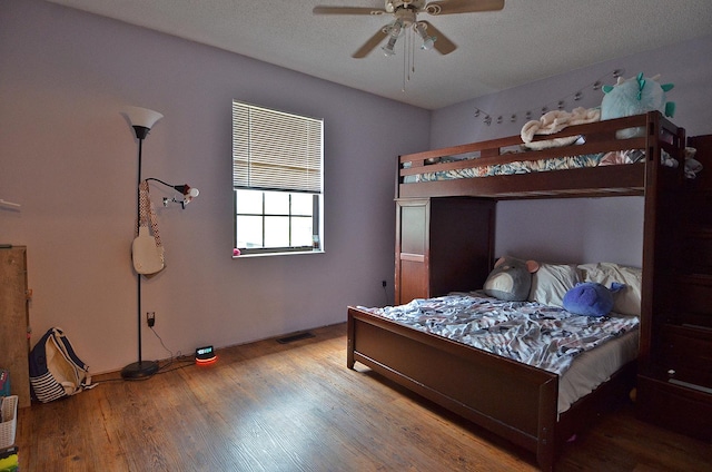 bedroom with a ceiling fan and wood finished floors