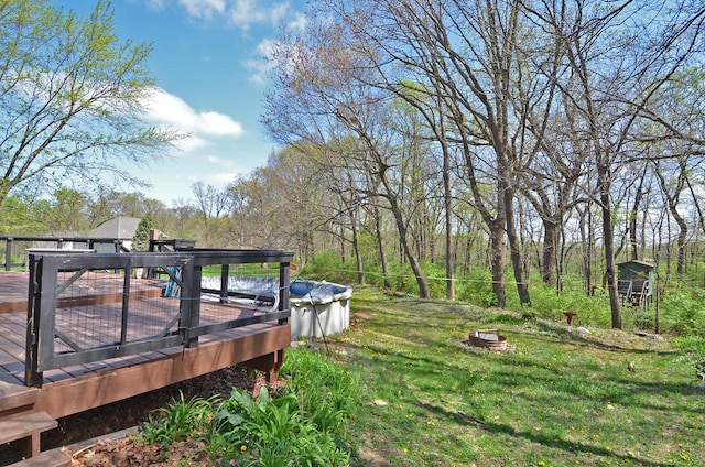 view of yard with an outdoor structure and a wooden deck