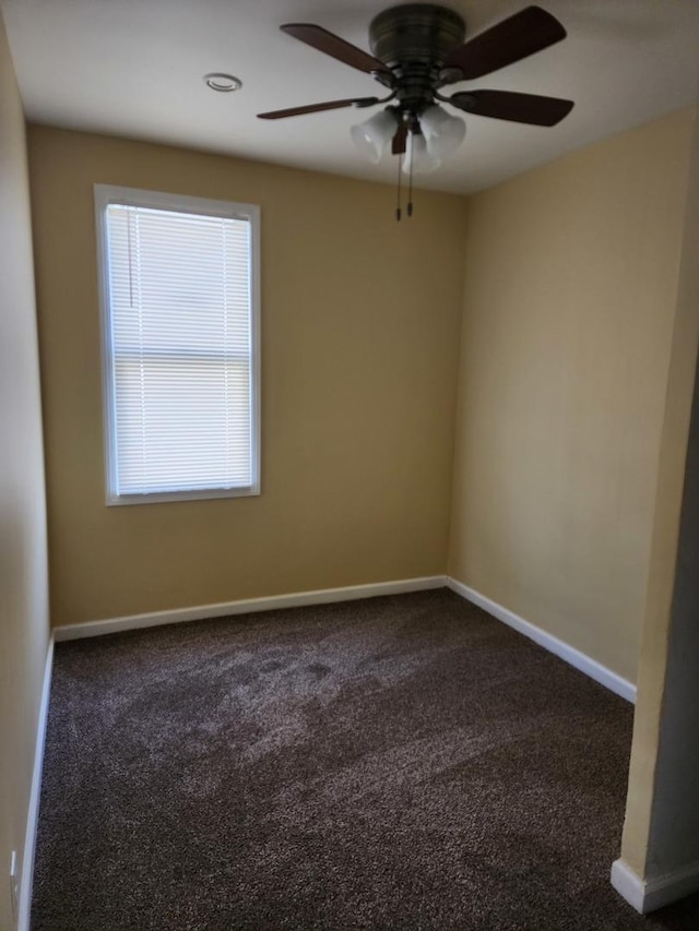 empty room featuring baseboards, a ceiling fan, and carpet floors