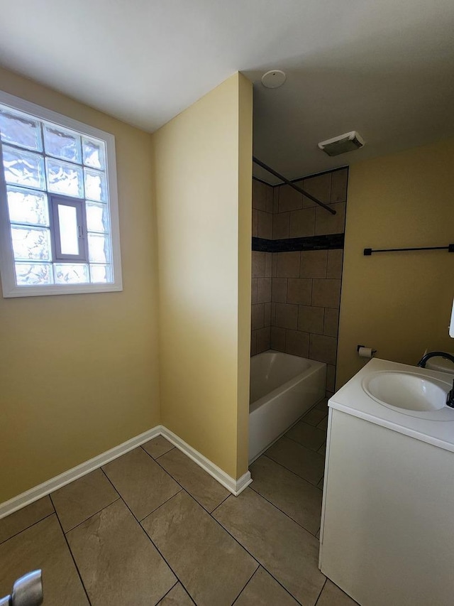 bathroom featuring tile patterned floors, vanity, tub / shower combination, and baseboards