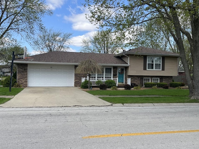 201 Meadows Rd S, Bourbonnais, IL 60914 - tri-level home with brick siding, driveway, an attached garage, a front yard, and covered porch