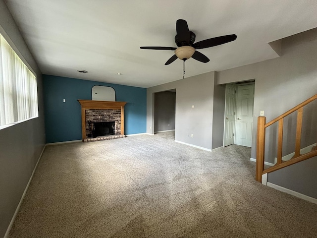201 Meadows Rd S, Bourbonnais, IL 60914 - unfurnished living room featuring ceiling fan, carpet floors, a brick fireplace, baseboards, and stairway