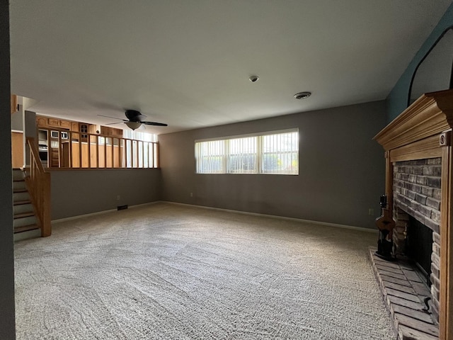 201 Meadows Rd S, Bourbonnais, IL 60914 - unfurnished living room featuring a fireplace, ceiling fan, carpet flooring, and stairs