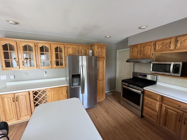 201 Meadows Rd S, Bourbonnais, IL 60914 - kitchen with appliances with stainless steel finishes, under cabinet range hood, glass insert cabinets, and light wood finished floors