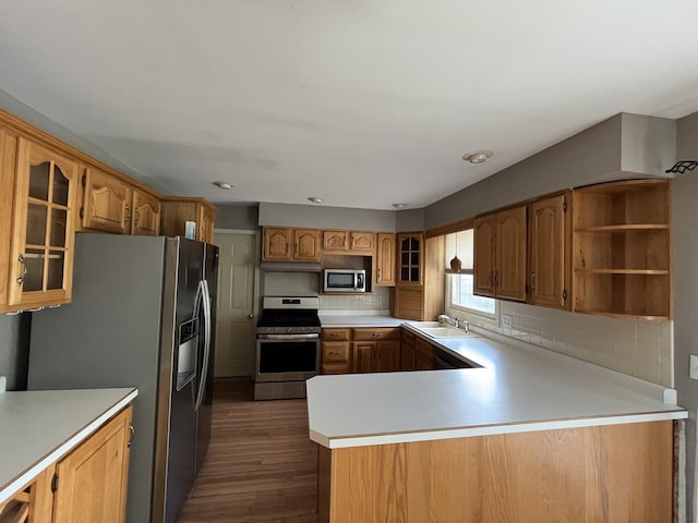 201 Meadows Rd S, Bourbonnais, IL 60914 - kitchen with appliances with stainless steel finishes, wood finished floors, light countertops, glass insert cabinets, and tasteful backsplash