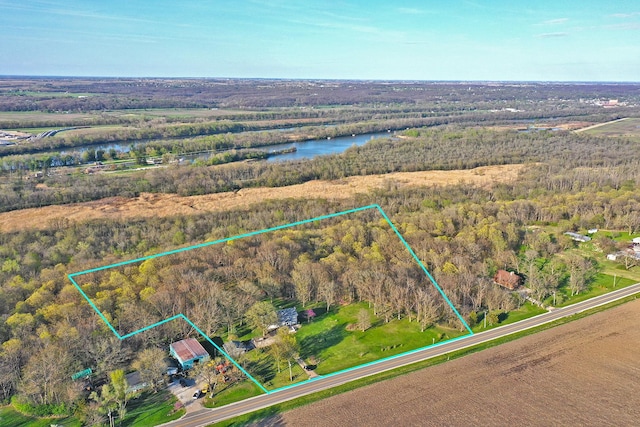 drone / aerial view with a forest view and a water view