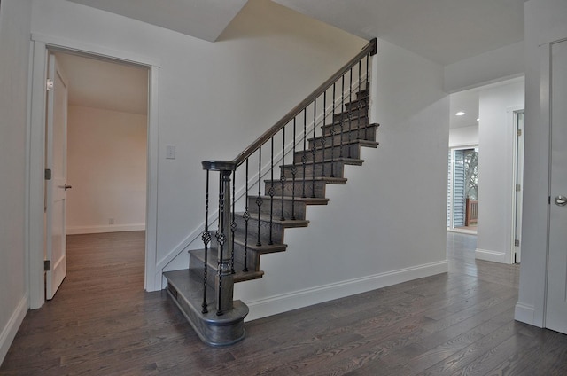 staircase with wood finished floors and baseboards