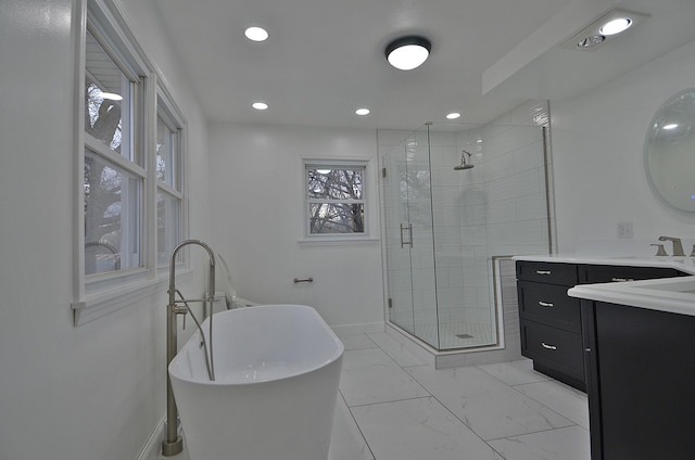 full bathroom with recessed lighting, vanity, a freestanding tub, a stall shower, and baseboards