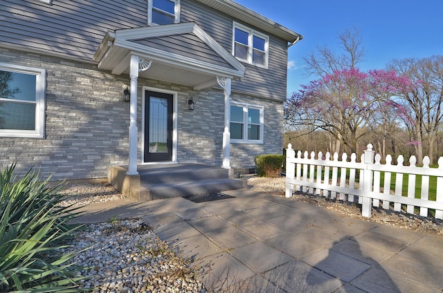 doorway to property with fence