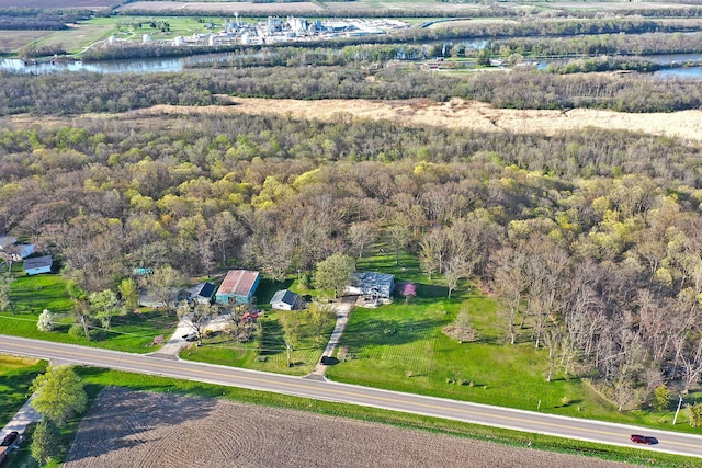 birds eye view of property featuring a water view and a view of trees
