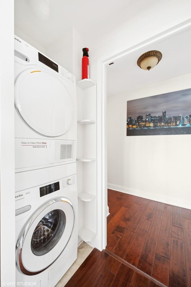 155 N Harbor Dr Unit 1112-13, Chicago, IL 60601 - laundry area featuring wood-type flooring, stacked washer / drying machine, laundry area, and baseboards