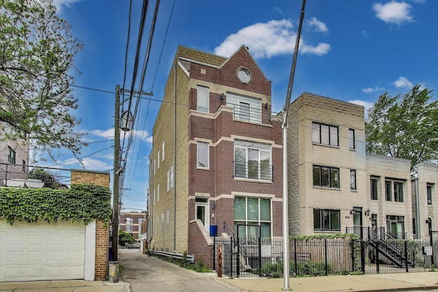 512 N Claremont Ave Unit 2, Chicago, IL 60612 - view of property with a fenced front yard and a garage