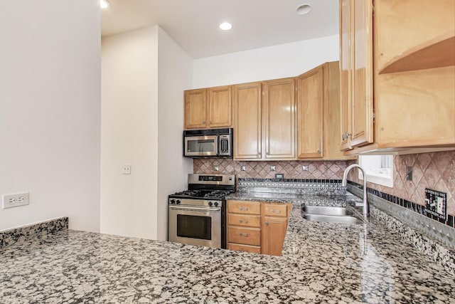 512 N Claremont Ave Unit 2, Chicago, IL 60612 - kitchen featuring stainless steel appliances, a sink, tasteful backsplash, stone counters, and recessed lighting